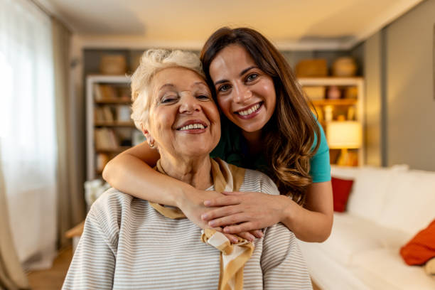 Family member warmly embracing elderly parent at a senior living community